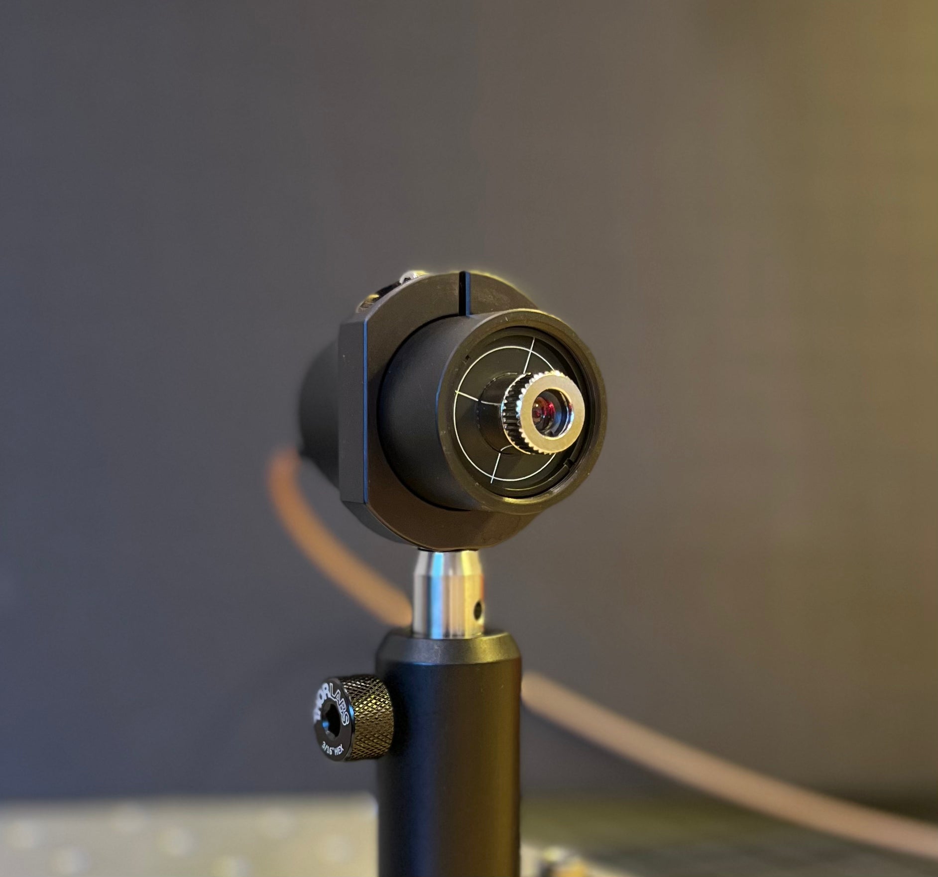 Front view of nanosecond pulse laser diode (NLD-01) showing collimation lens and 650 nm output.